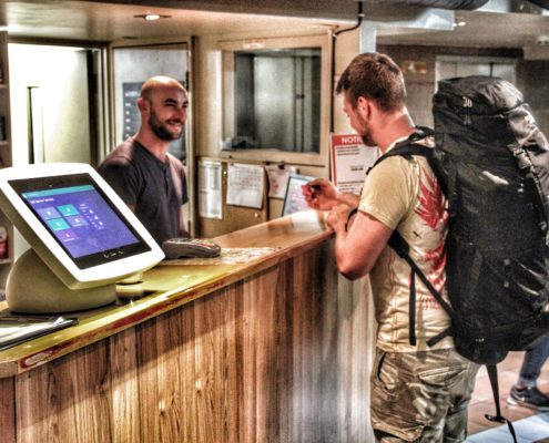 Image of the Choice Backpackers recepting showing a guest checking in